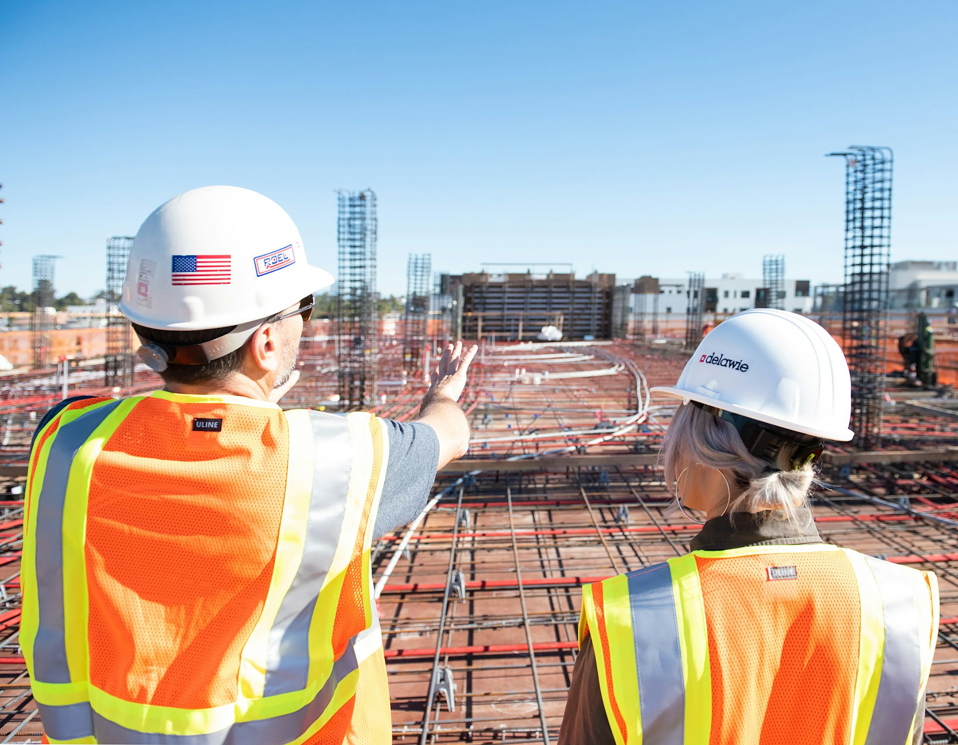 civil engineers looking discussing construction project civil engineers looking over and discussing plans at a construction site