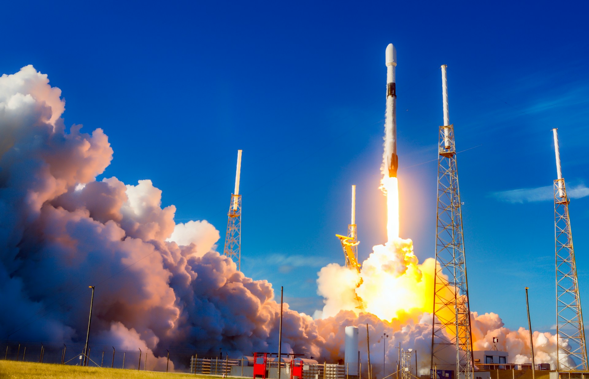 rocket launching rocket launching with fire and smoke against blue sky