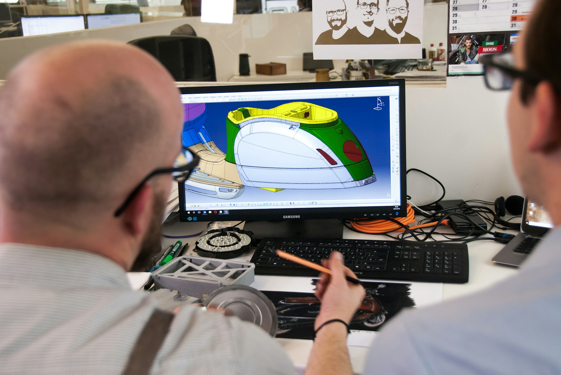 two-men-doing-CAD two men looking at computer screen with CAD (computer aided design) rendering