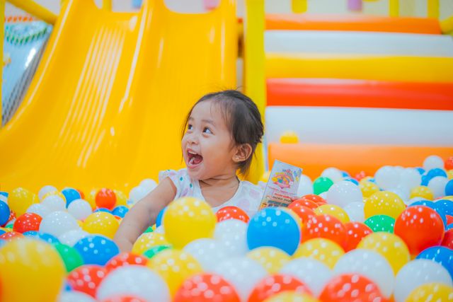 girl in ball pit girl in indoor playground ball pit