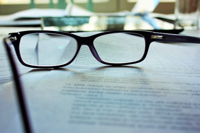glasses on book pages expert witness eyeglasses on book pages