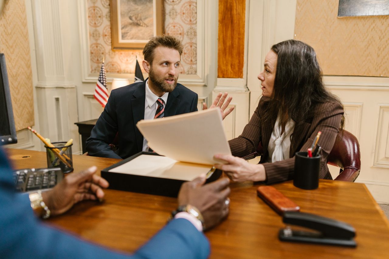 three people in office having a discussion estate and trust expert witness